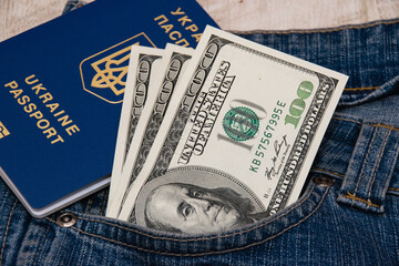 Passport and money in the pocket of blue denim pants close up