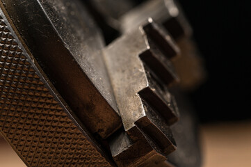 Assortment of steel machinists tooling for metalwork with gears, metal lathe chuck, macro close up details