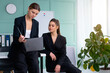 © Andrii - Young women leaders are checking financial statements from paper documents. Two female confident business worker dressed black suit in office checking financial document