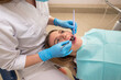 © Tania - Dentist-hygienist conducts a teeth cleaning procedure for a girl in a dental clinic. Removal of tartar.