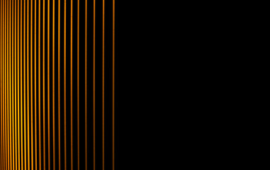 Colorful light yellow-orange graphic object line image with light against black background at night.