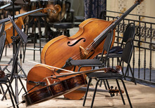 The Cello Lies On The Stage Next To The Classical Instruments During The Intermission
