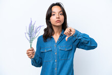 Young Hispanic Woman Holding Lavender Isolated On White Background Showing Thumb Down With Negative Expression