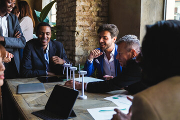 Multiethnic business people working on sustainable renewable energy project inside office - Green alternative electricity concept