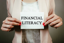 Business Woman Holding Paper Sheet With Text Financial Literacy. Business Concept