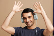 © SHOTPRIME STUDIO - man Listening to music with headphones fun beige background