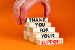 Thank you for support symbol. Concept words Thank you for your support on wooden blocks on a beautiful orange table orange background. Businessman hand. Business and thank you for support concept.