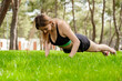 © platinumArt - Young beautiful woman wearing sportive clothes on city park, outdoors. Confident girl doing push up on grass. Healthy life outdoor sport concept.