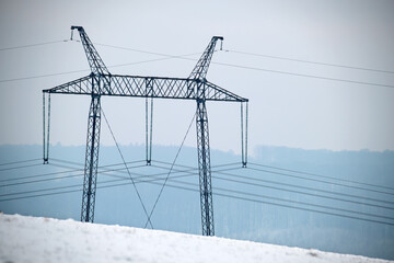 Steel pillar with high voltage electric power lines delivering electrical energy through cable wires on long distance