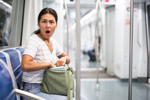 Oriental Woman Feeling Shocked When She's Discovered Theft From Her Shoulder Bag In Metropolitan Train.