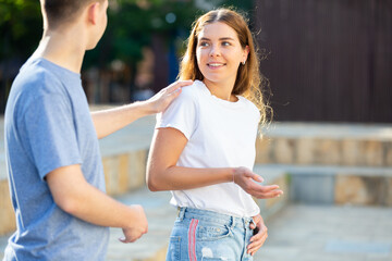 Girl gesturing stop to man flirting with her on street