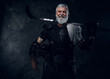 © Fxquadro - Shot of glad aged hockey player dressed in sportive uniform holding hockey stick.