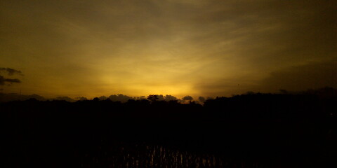 golden yellow sky at sunset in a countryside