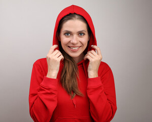 Smiling girl puts on a hood with red hoodie