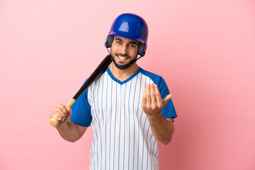 Wall Mural - Baseball player with helmet and bat isolated on pink background inviting to come with hand. Happy that you came