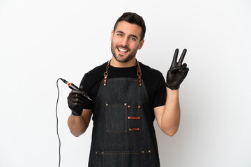 Canvas Print - Tattoo artist man isolated on white background smiling and showing victory sign