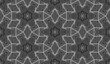 Hexagonal seamless pattern of white lines on black. Ceremonial repeatable ornament in moire style.