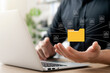 © Thapana_Studio - Document management system concept, business man holding folder and document icon software, searching and managing files online document database, for efficient archiving and company data.