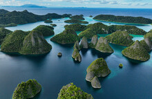 Aerial View Of Scattered Islands With Blue Ocean Water At Wajag Island, Raja Ampat, West Papua, Indonesia.