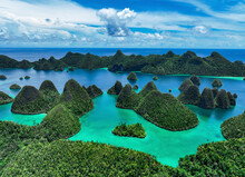 Aerial View Of Scattered Islands With Blue Ocean Water At Wajag Island, Raja Ampat, West Papua, Indonesia.