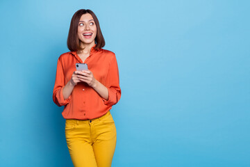 Poster - Portrait of attractive cheerful curious girl using device copy space media news like isolated over bright blue color background