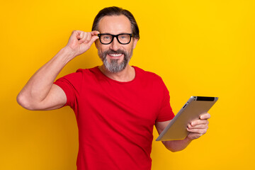 Sticker - Photo of funny sweet retired man wear red t-shirt spectacles chatting modern device isolated yellow color background