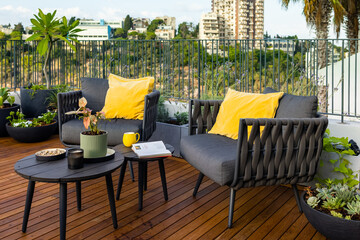 Amazing sun terrace with sofa armchairs, coffee tables, flower pots, planters and wonderful plant