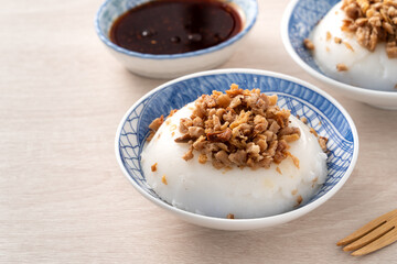 Wall Mural - Taiwanese savory rice pudding Wa gui with chopped dried radish and soy sauce