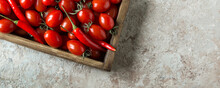 Wooden Box With Fresh Cherry Tomatoes And Chili Peppers On The Table, Space For Text
