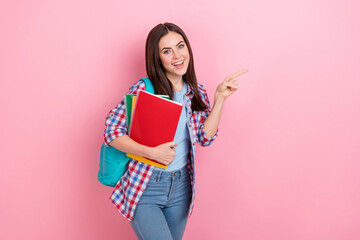 Sticker - Photo of smiling pretty girl studying in college point finger empty space promote courses isolated on pink color background