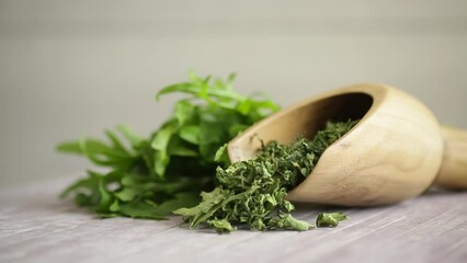 Wall Mural - dried green organic arugula, seasoning, on wooden table.