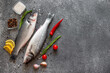 raw sea bass fish on stone background with copy space for your text