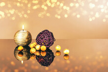 A Lit Candle And Wooden Balls As A Concept Of Meditation, Peace Of Mind, Comfort And Order, Religion And Faith.