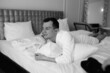 © Underwater girls - in the photo, a smug man in a bathrobe in hotels lying down enjoying the view from the window
