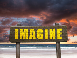 Imagine sign at a beautiful beach for creative thinking motivational concept.