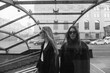 © Karyna Bartashevich/Stocksy - black and white portrait of two girls walking in the city at the entrance to the subway