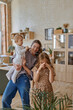 © Tatiana Timofeeva/Stocksy - mom and kids play with soap bubbles