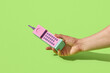 © Yaroslav Danylchenko/Stocksy - Male hand holding papercraft retro mobile phone