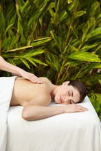 Woman Receiving An Exfoliating Salt Scrub Massage Spa Treatment