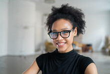 Portrait Of A Happy Woman In Glasses - A Freelancer Working In An Office