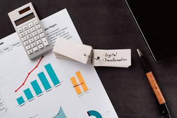 Poster - There is word card on the desk about Digital Transformation. It's placed with dummy documents.
