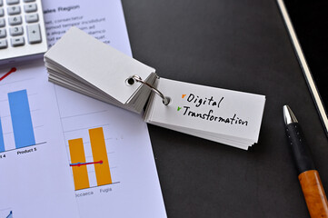 Poster - There is word card on the desk about Digital Transformation. It's placed with dummy documents.