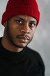 © Ezequiel Giménez/Stocksy - Serious black guy in hat looking at camera