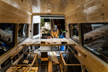 Man Working At Home Workshop Converting Van Into Camper