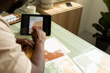 Freelance Digital Creator Using Tablet At Work