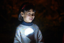 Closeup Cute Little Chinese Girl Playing With A Glowing Light Bulb