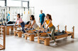 © Santi Nuñez/Stocksy - Group of people working out in gym