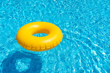 Yellow Ring Floating In Blue Swimming Pool. Inflatable Ring, Rest Concept