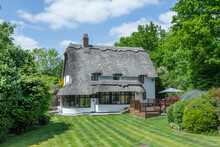 Traditional Thatch Cottage In England. Set In The Garden.