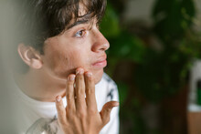 Teen Boy Massaging His Face Portrait